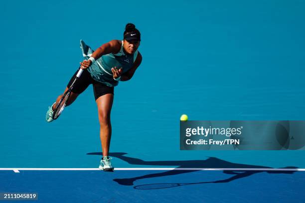 Caroline Garcia of France serves against Naomi Osaka of Japan in the third round of the Miami Open at the Hard Rock Stadium on March 24, 2024 in...