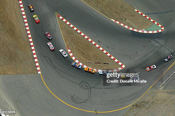 General view of the cars taking a turn in a pack during the NASCAR Winston Cup Dodge Save Mart 350 at the Infineon Raceway on June 22, 2003 in...