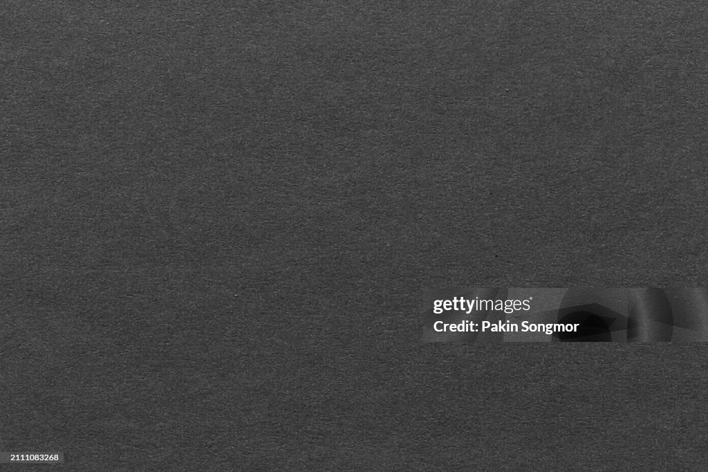 Black color eco recycled kraft paper sheet texture cardboard background.