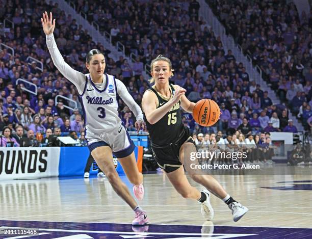 Kindyll Wetta of the Colorado Buffaloes dribbles the ball up court against Jaelyn Glenn of the Kansas State Wildcats in the second half during the...