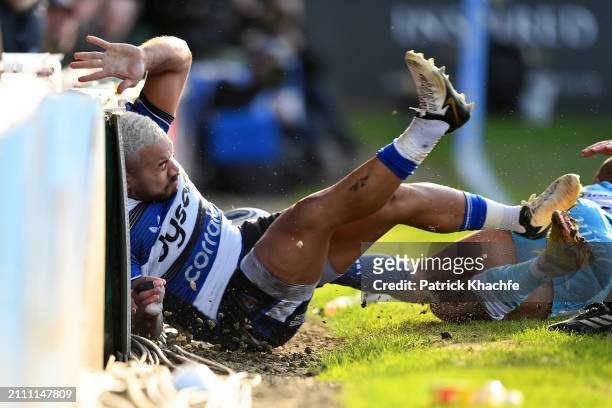 Ollie Lawrence of Bath Rugby goes crashing into the advertising boards during the Gallagher Premiership Rugby match between Bath Rugby and Sale...