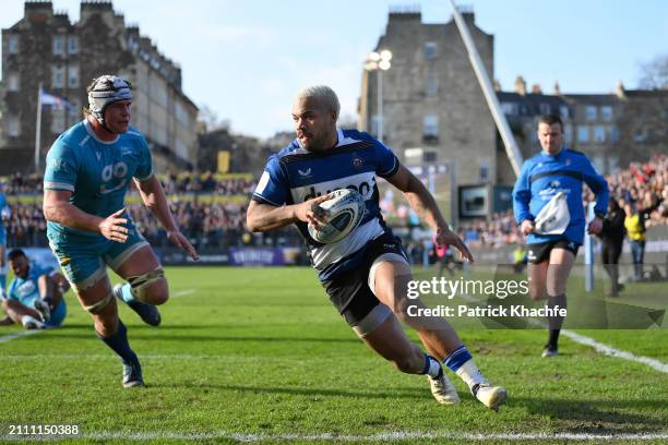 Ollie Lawrence of Bath Rugby runs in his team's fifth try during the Gallagher Premiership Rugby match between Bath Rugby and Sale Sharks at...