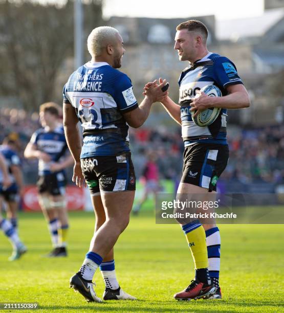 Ollie Lawrence of Bath Rugby celebrates scoring his side's fifth try with team-mate Finn Russell during the Gallagher Premiership Rugby match between...