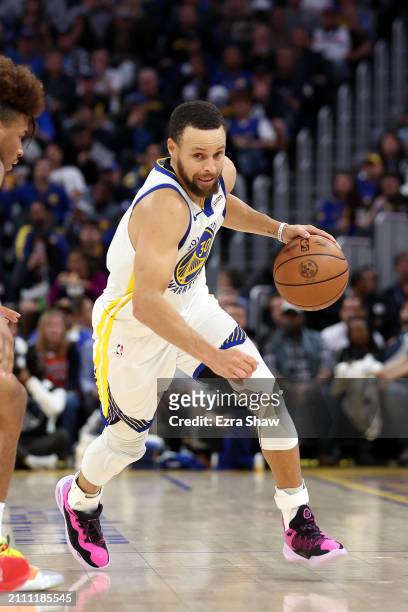 Stephen Curry of the Golden State Warriors dribbles the ball against the New York Knicks at Chase Center on March 18, 2024 in San Francisco,...