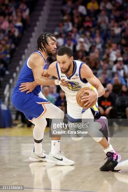 Stephen Curry of the Golden State Warriors is guarded by Jalen Brunson of the New York Knicks at Chase Center on March 18, 2024 in San Francisco,...