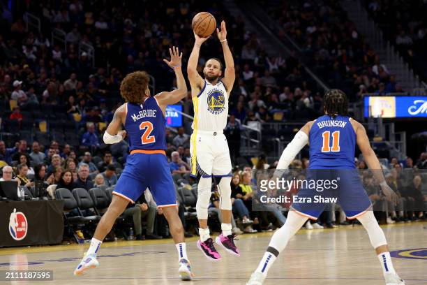Stephen Curry of the Golden State Warriors shoots over Miles McBride of the New York Knicks at Chase Center on March 18, 2024 in San Francisco,...