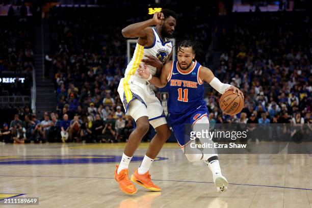 Jalen Brunson of the New York Knicks is guarded by Andrew Wiggins of the Golden State Warriors at Chase Center on March 18, 2024 in San Francisco,...