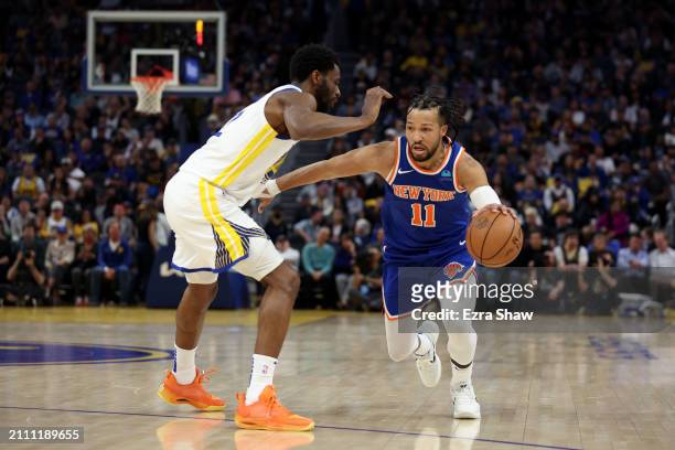 Jalen Brunson of the New York Knicks is guarded by Andrew Wiggins of the Golden State Warriors at Chase Center on March 18, 2024 in San Francisco,...