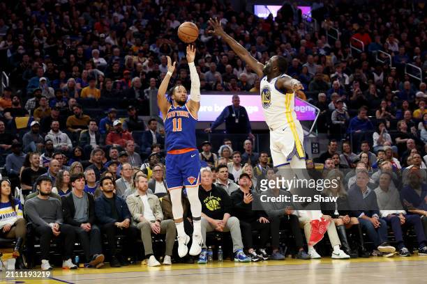 Jalen Brunson of the New York Knicks shoots over Draymond Green of the Golden State Warriors at Chase Center on March 18, 2024 in San Francisco,...
