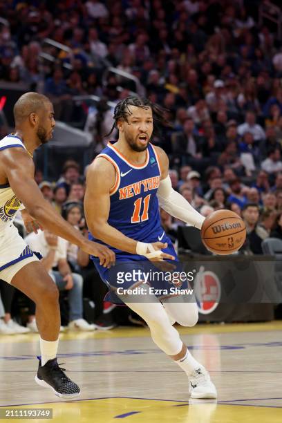 Jalen Brunson of the New York Knicks is guarded by Chris Paul of the Golden State Warriors at Chase Center on March 18, 2024 in San Francisco,...