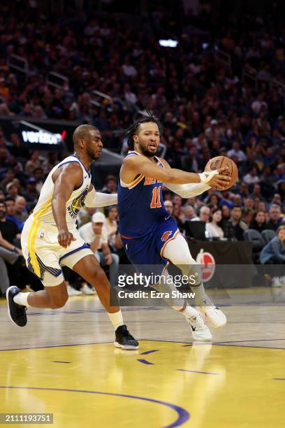 Jalen Brunson of the New York Knicks is guarded by Chris Paul of the Golden State Warriors at Chase Center on March 18, 2024 in San Francisco,...