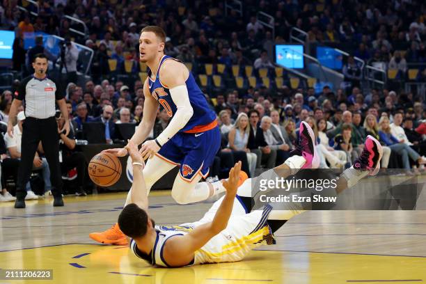 Donte DiVincenzo of the New York Knicks dribbles past Stephen Curry of the Golden State Warriors at Chase Center on March 18, 2024 in San Francisco,...