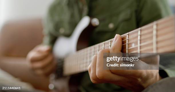 man hand's playing guitar - guitar stock pictures, royalty-free photos & images