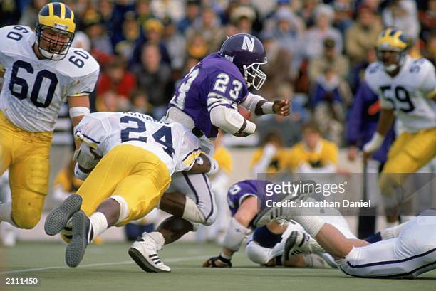 Byron Sanders of Northwestern University Wildcats carries the ball during a game against the University of Michigan Wolverines in the 1988 season.