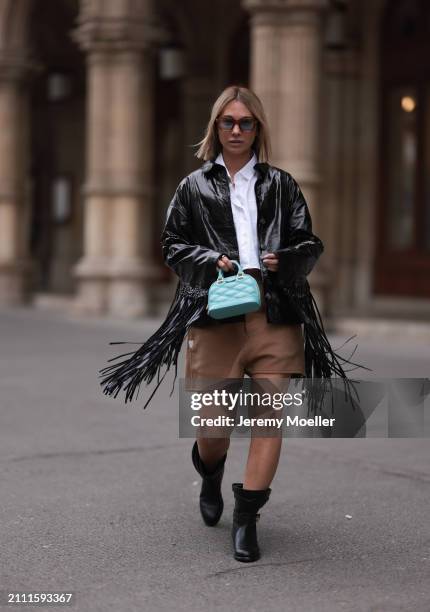 Karin Teigl seen wearing Jacques Marie Mage brown sunglasses with blue lenses, By Aylin Koenig white cotton buttoned shirt, Herskind black leather...