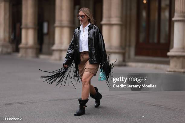 Karin Teigl seen wearing Jacques Marie Mage brown sunglasses with blue lenses, By Aylin Koenig white cotton buttoned shirt, Herskind black leather...