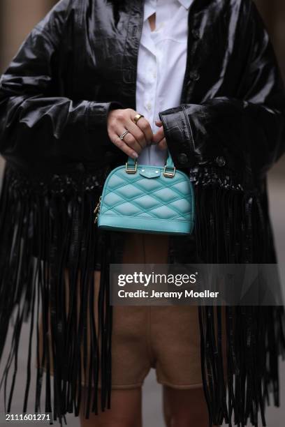 Karin Teigl seen wearing By Aylin Koenig white cotton buttoned shirt, Herskind black leather fringe jacket, Louis Vuitton brown wool shorts, Louis...