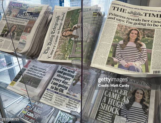 Newspaper front pages, including The Daily Telegraph, Daily Express, The Star, The Daily Mail, The Guardian and The Times display an image of...