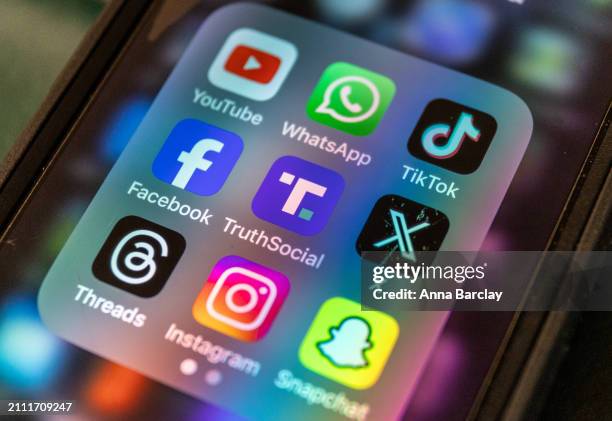 In this photo illustration a smartphone screen displays the logo of Donald Trump's Truth Social app March 25 2024 in Bath, England. Former US...