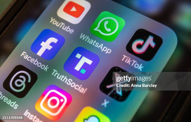 In this photo illustration a smartphone screen displays the logo of Donald Trump's Truth Social app March 25 2024 in Bath, England. Former US...