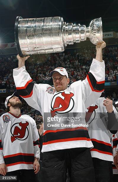 Tommy Albelin of the New Jersey Devils hoists the Stanley Cup after defeating the Mighty Ducks of Anaheim in game seven of the 2003 Stanley Cup...