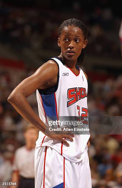 Swin Cash of the Detroit Shock looks on against the New York Liberty during the game at The Palace of Auburn Hills on June 20, 2003 in Auburn Hills,...