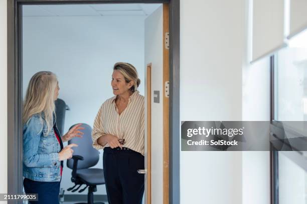 walking her patient to the door - hospital doorway stock pictures, royalty-free photos & images