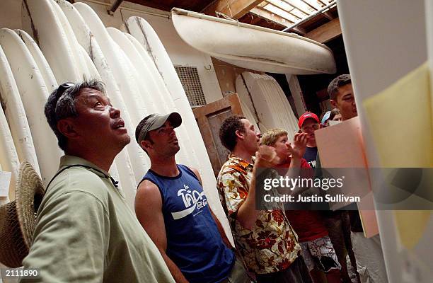 Club Ed International Surfing School attendees look at surfboard blanks during a tour of the Pearson Arrow Surfboard factory June 25, 2003 in...