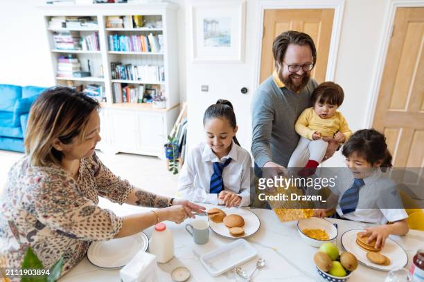 asian family at home, father and mother helping kids to prepare for school - northern european descent stock pictures, royalty-free photos & images