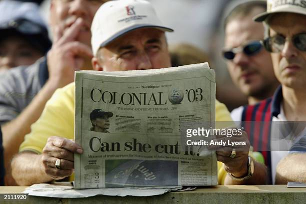 Fan holds a newspaper about Annika Sorenstam of Sweden playing in a men's PGA game during the first round of the Bank of America Colonial at the...