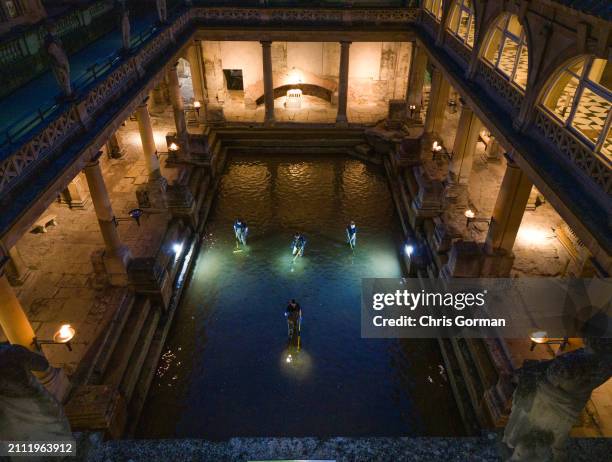 The Roman Baths in the City of Bath undergo a spring clean by torchlight on March 18,2024 in Bath, England. The spring clean of the Great Bath sees...