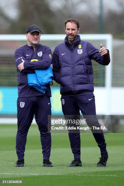 Gareth Southgate, Manager of England men's senior team, and Steve Holland, Assistant Manager of England, talk during a training session at Tottenham...