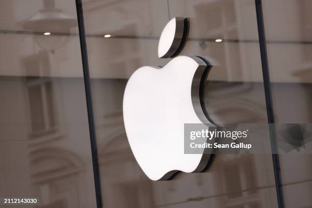 The Apple logo hangs on an Apple Store on March 25, 2024 in Berlin, Germany. The European Commission is launching an investigation into Apple, Meta...