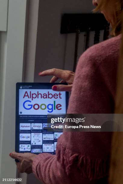 Woman with a tablet with Alphabet Google on it, on 25 March, 2024 in Madrid, Spain. Brussels launches the first three sanctioning files, under the...