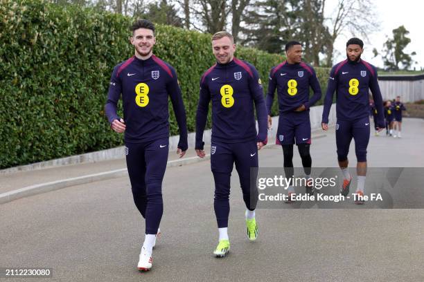 Declan Rice, Jarrod Bowen, Ezri Konsa and Joe Gomez of England walk to a training session at Tottenham Hotspur Training Centre on March 25, 2024 in...