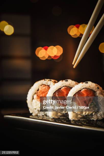 close-up of sushi served in plate on table - industria alimentaria fotografías e imágenes de stock