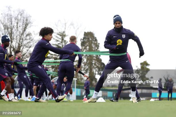 Rico Lewis and Marcus Rashford of England in action during a training session at Tottenham Hotspur Training Centre on March 25, 2024 in Enfield,...