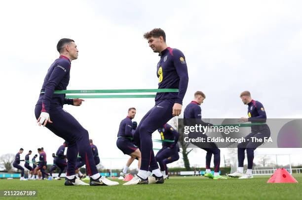 Phil Foden, John Stones and teammates of England in action during a training session at Tottenham Hotspur Training Centre on March 25, 2024 in...