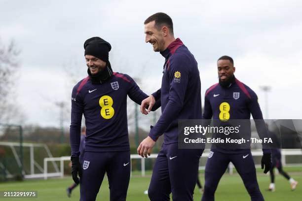 James Maddison and Lewis Dunk of England react during a training session at Tottenham Hotspur Training Centre on March 25, 2024 in Enfield, England.