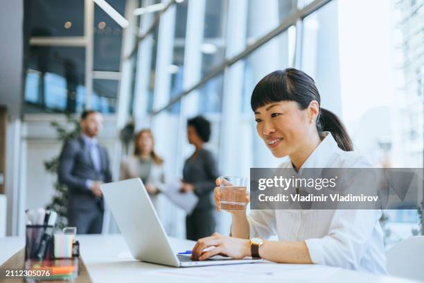 businesswoman with water glass and phone - round table discussion women stock pictures, royalty-free photos & images