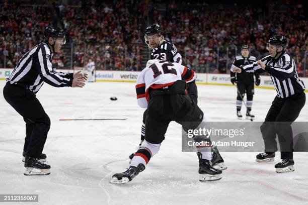 Mark Kastelic of the Ottawa Senators fights Kurtis MacDermid of the New Jersey Devils during the first period at the Prudential Center on March 23,...