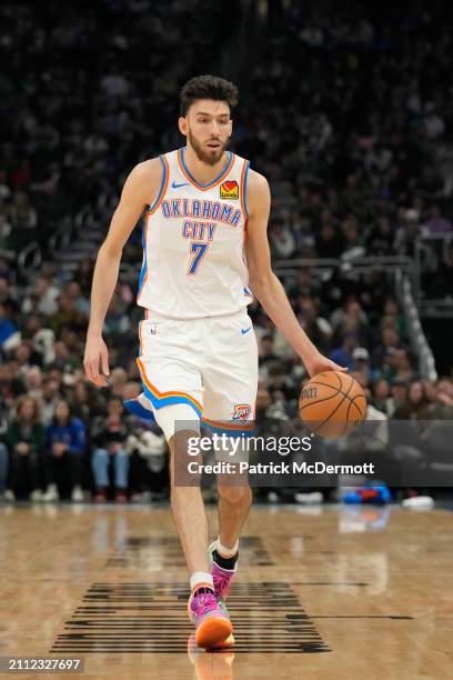 Chet Holmgren of the Oklahoma City Thunder dribbles the ball during the first half against the Milwaukee Bucks at Fiserv Forum on March 24, 2024 in...