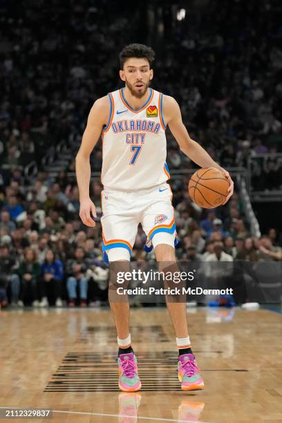 Chet Holmgren of the Oklahoma City Thunder dribbles the ball during the first half against the Milwaukee Bucks at Fiserv Forum on March 24, 2024 in...