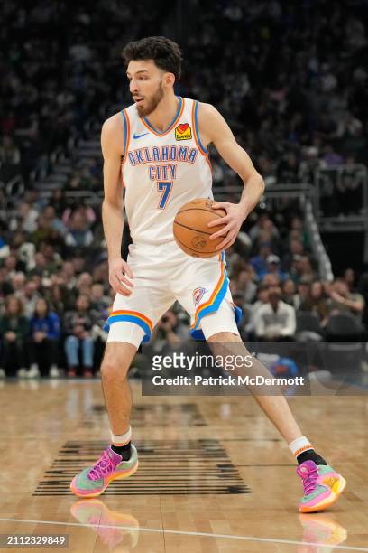 Chet Holmgren of the Oklahoma City Thunder dribbles the ball during the first half against the Milwaukee Bucks at Fiserv Forum on March 24, 2024 in...