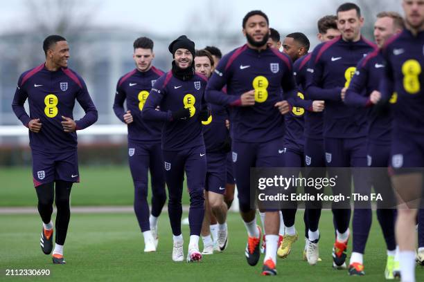 Ezri Konsa, James Maddison and teammates of England warm up during a training session at Tottenham Hotspur Training Centre on March 25, 2024 in...