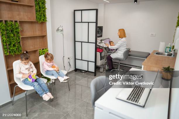 female pediatrician examining little girl with ultrasound at the medical clinic - twin ultrasound stock pictures, royalty-free photos & images