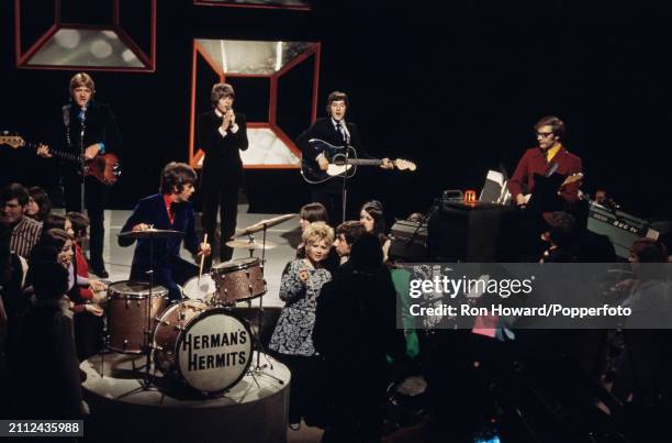 English pop group Herman's Hermits perform on the set of a pop music television show in London circa 1969. Members of the band are, from left,...