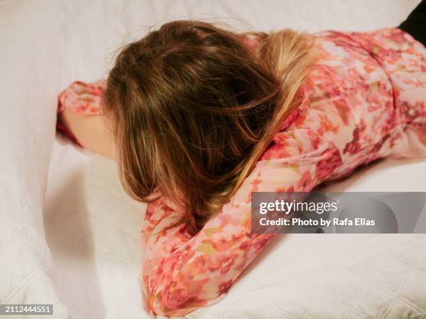 woman lying down on bed - face down stock pictures, royalty-free photos & images