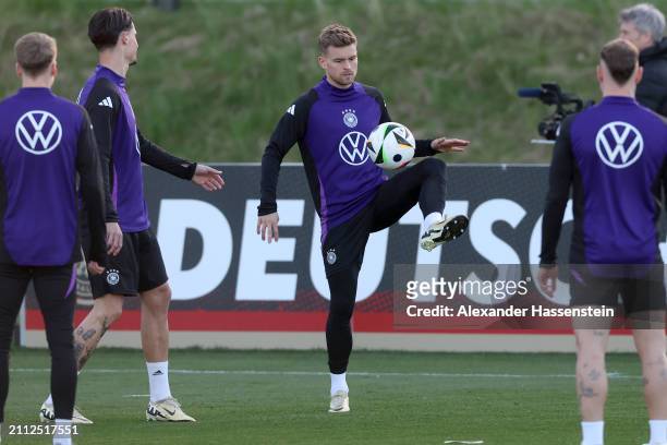 Maximilian Mittelstädt of Germany plays the ball during a training session of Team Germany at DFB Campus on March 25, 2024 in Frankfurt am Main,...