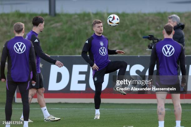 Maximilian Mittelstädt of Germany plays the ball during a training session of Team Germany at DFB Campus on March 25, 2024 in Frankfurt am Main,...
